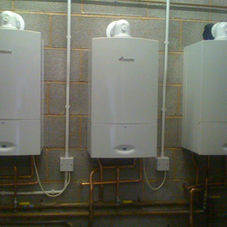 Triple wall-mounted boiler system for a large property heating project