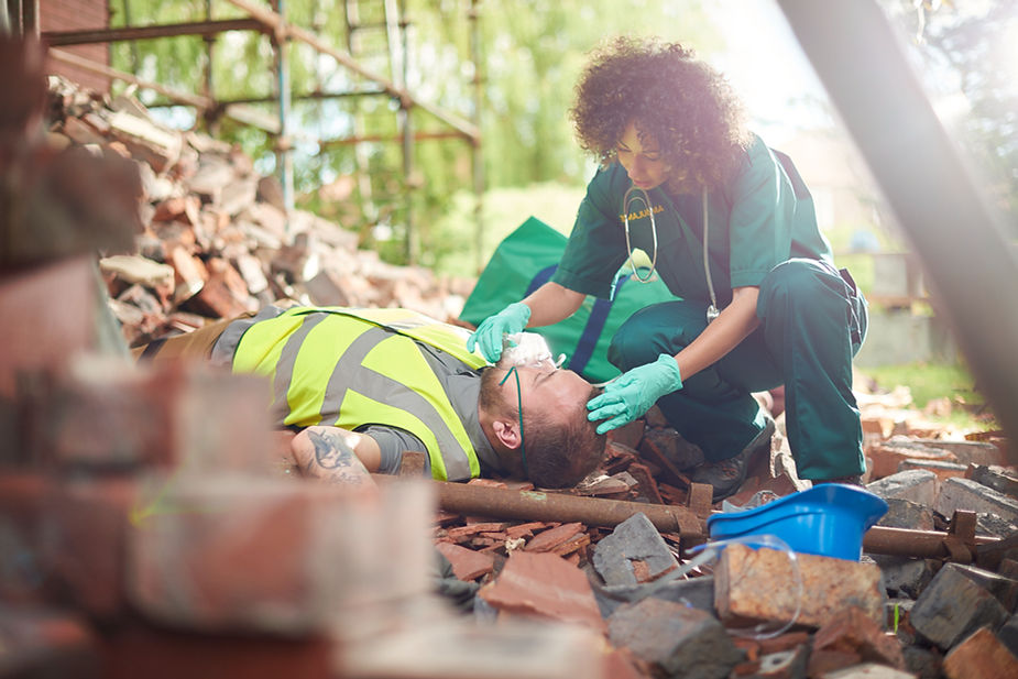 A British paramedic attending to an injured construction worker