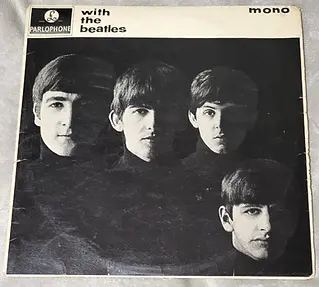 Black and white photograph of four young men’s faces arranged in a square composition on a record sleeve