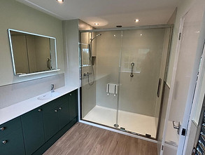 Accessible wet room with walk-in glass shower and wooden bench