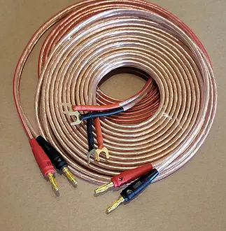 A coiled pair of copper speaker cables