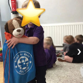 child hugging a toy bear