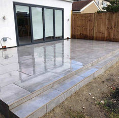 A modern grey tiled patio with steps