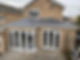 The exterior of a house with new windows and doors.