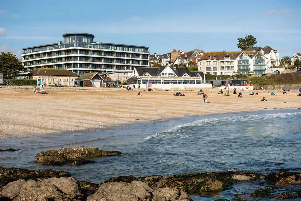 Beach scene with gentle waves and rocky shoreline