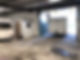 Interior of a garage with high ceilings, two caravans parked inside