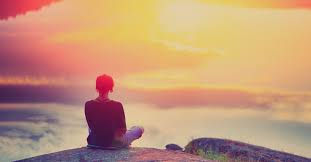 woman sitting in the sun meditating