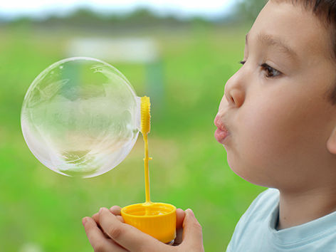 a child blowing bubbles