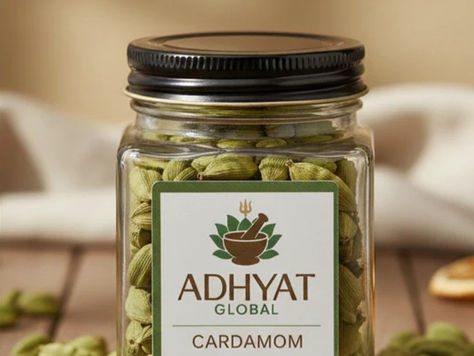 Adhyat Global Cardamom whole green pods in a glass jar, shade-grown in Kerala highlands and sun-dried to preserve essential oils.