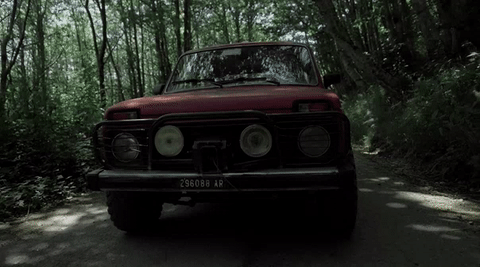 Red car in the wood - The breather frame by tanello prodution