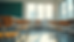 Eye-level view of a modern international school classroom with empty desks and a vacant teacher's chair