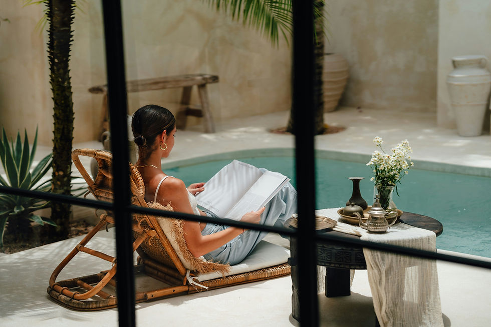 Woman reading beside a villa pool with discreet perimeter sensors and concealed security cameras