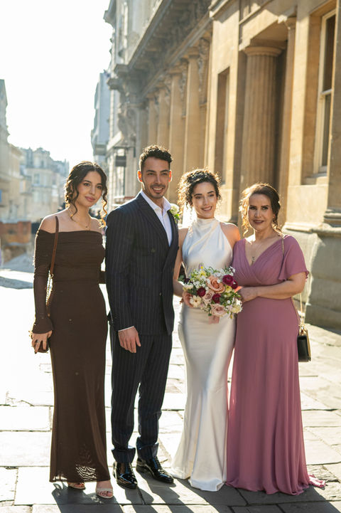 Bride and groom surrounded by close family and friends during a joyful English wedding celebration, captured by Win.Co Photography in Buckinghamshire.
