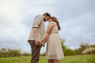 Outdoor engagement shoot in Buckinghamshire with couple embracing in field