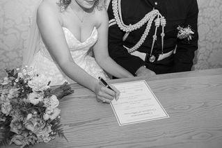 Bride and groom signing marriage certificate at Beaconsfield Registry Office 