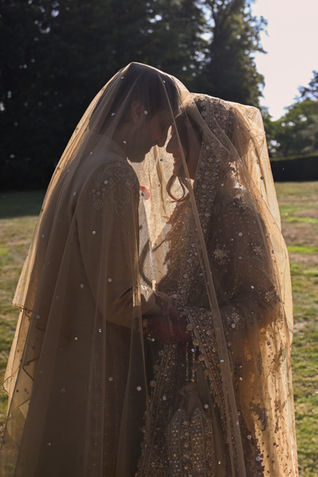 English countryside wedding ceremony under open skies in Northamptonshire, photographed by Win.Co Photography, featuring rustic décor, wooden chairs, and joyful guests.