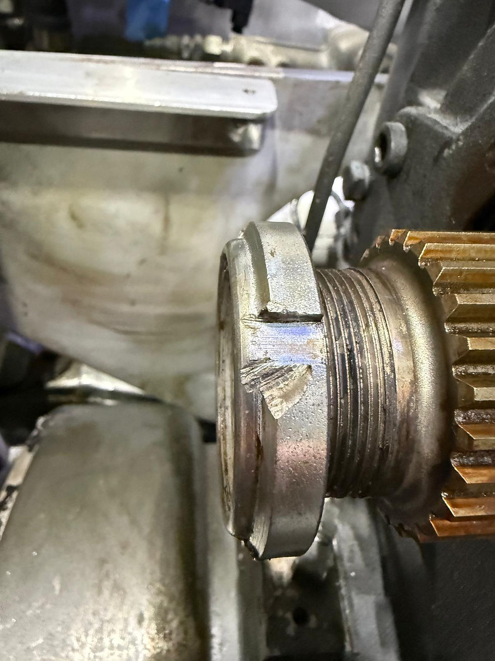 Butched retaining nut resulting from careless workmanship by Naval Yachts.