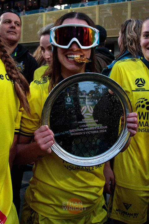 Footballer celebrates with trophy