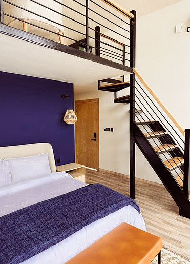 Beautiful bedroom with stairs going to loft