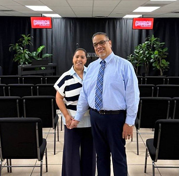 Pastors Joshua and wife standing together inside Compassion Church before service in Albuquerque, New Mexico.