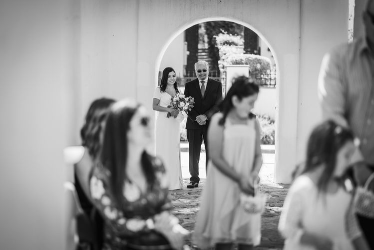 bride waiting with her dad to walk down the aisle 