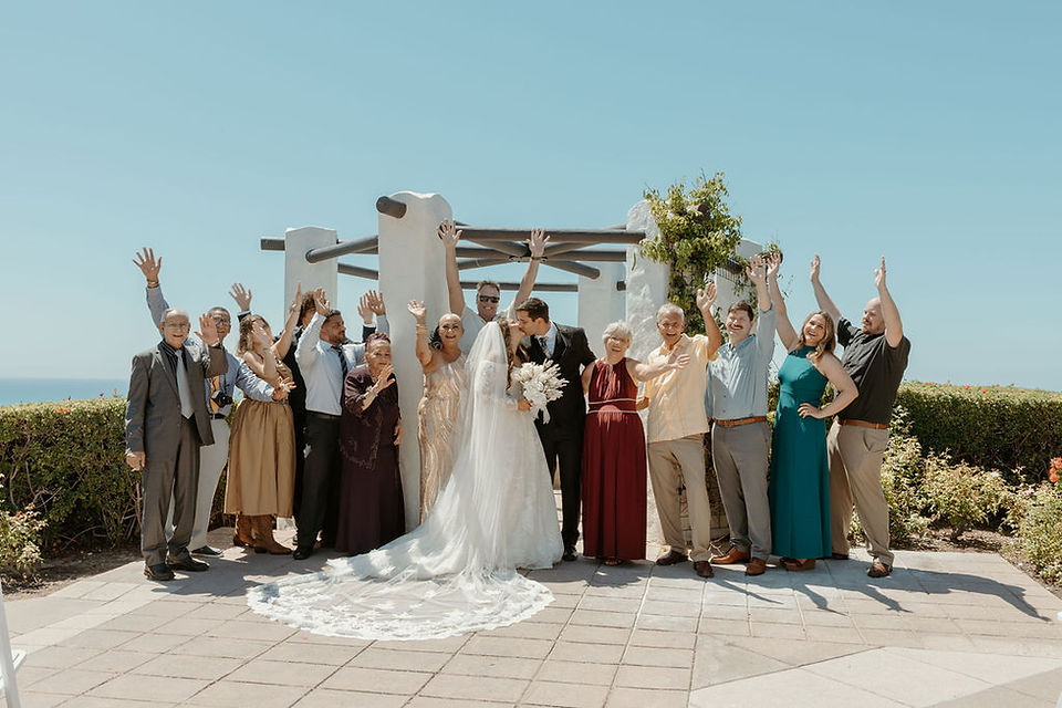 bride and groom kiss with guests cheering in front of palisades gazebo
