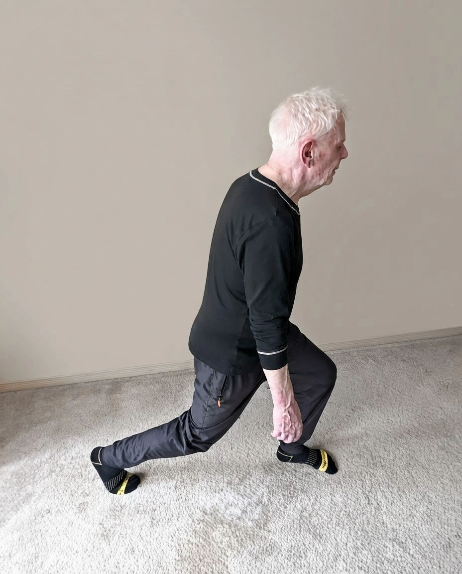 Elderly man doing a lunge step exercise.