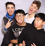 Four boys making funny faces for a birthday photo booth photo event
