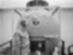 Alexei Leonov pokes his head through the porthole of a Soyuz orbital module mockup