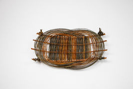 A 3D woven willow basketry sculpture featuring a rectangle flat weaving area, surrounded by 2 intersecting and overlapping circles. 