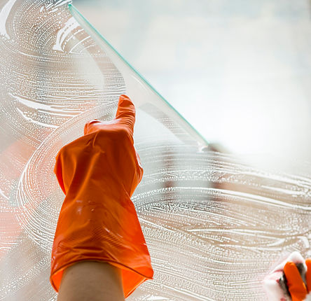 close-up-hand-with-rubber-glove-cleaning-window.jpg