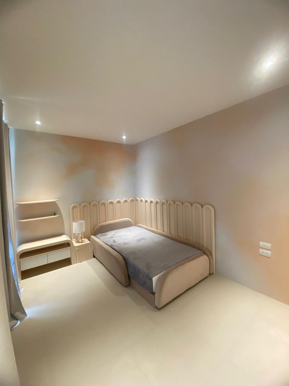 Minimalist bedroom with bed and shelves.