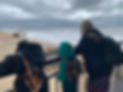 family looking at the beach view on a cloudy day