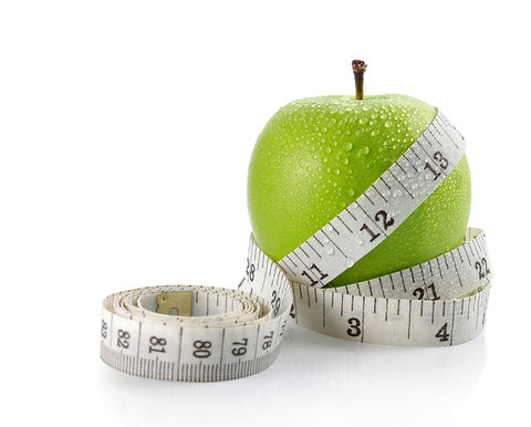 fresh apple with measuring tape. isolate