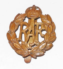 Very early RAF bronzed cap badge with a slider back.