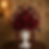 Deep red roses and anthuriums in a white urn vase