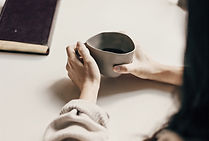 woman in white sweater holding black rou