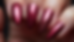 Close-up view of burgundy chrome nails with a glossy finish