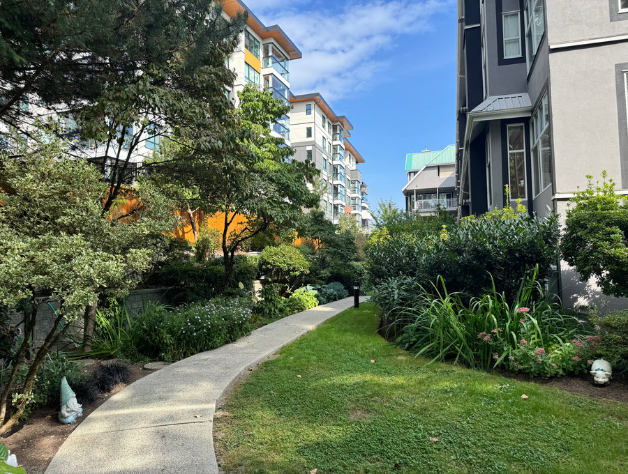 Landscaped grounds and pathway lighting at dusk