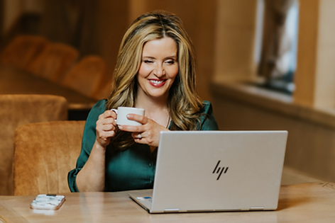Darci Lang Looking at a computer as someone contacts her and she responds to emails