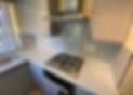kitchen installation with white countertops and cupboards