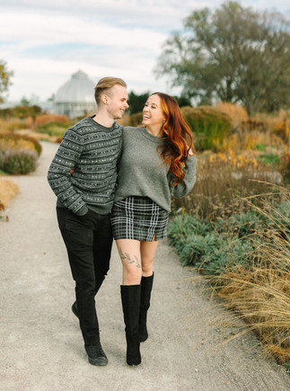 Alyssa and Jacob walking hand in hand on Belle Isle during a fall engagement session