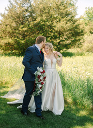 Wedding photographer capturing bride and groom portraits at Creekside Acres Event Barn in Goodrich, Michigan.