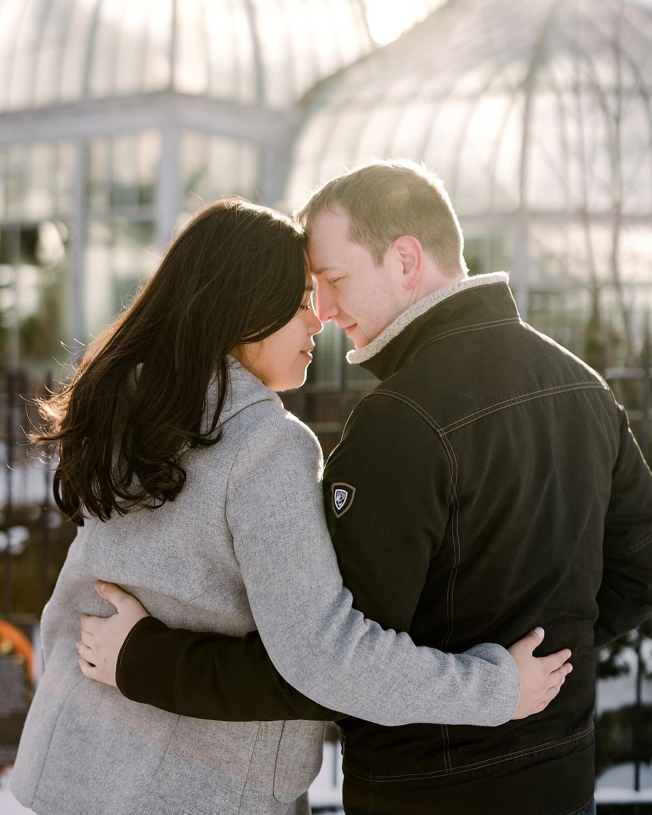 Couple sharing in intimate moment during the winter at Belle Isle Conservancy