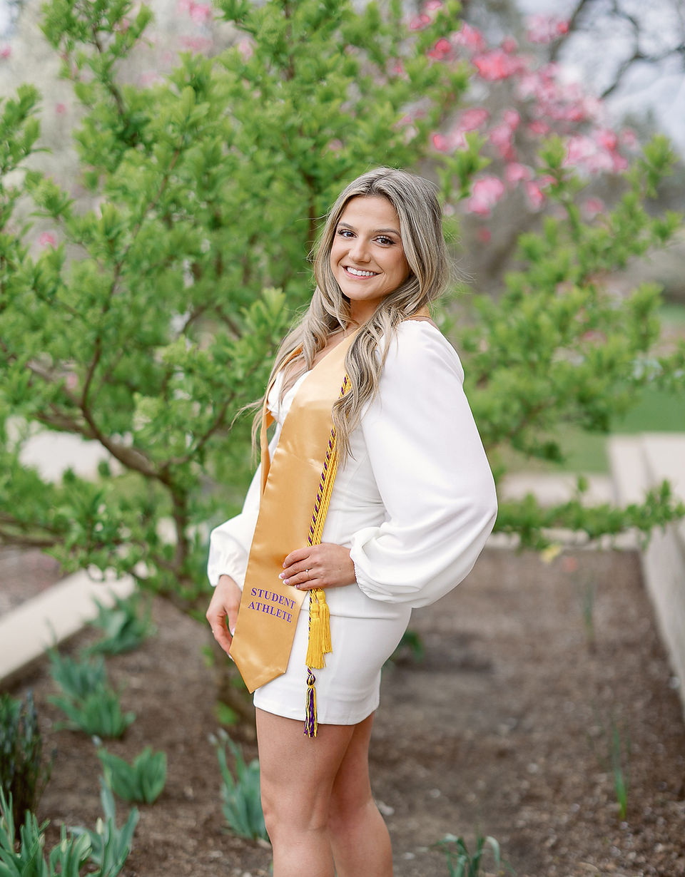 Detail shot of Megan's graduation attire, highlighting the intricate design of her gown and cap.