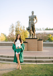 MSU graduates celebrating together near the Spartan Statue in East Lansing