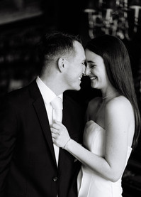 Intimate bar engagement session in Detroit with warm lighting and cocktails