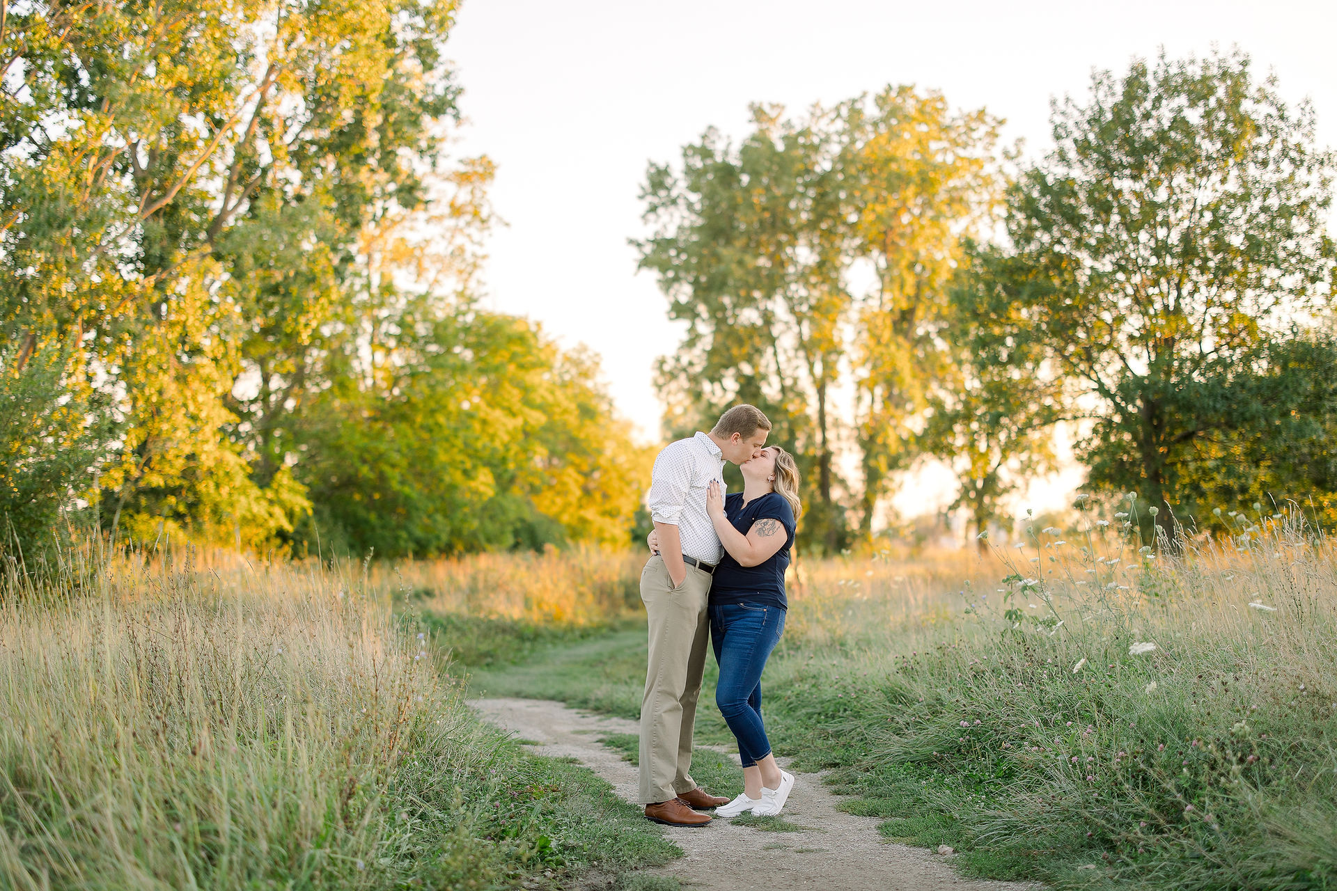A serene shot of Noah and Monica amidst the lush greenery of Belle Isle, showcasing the natural beauty of this enchanting engagement session.
