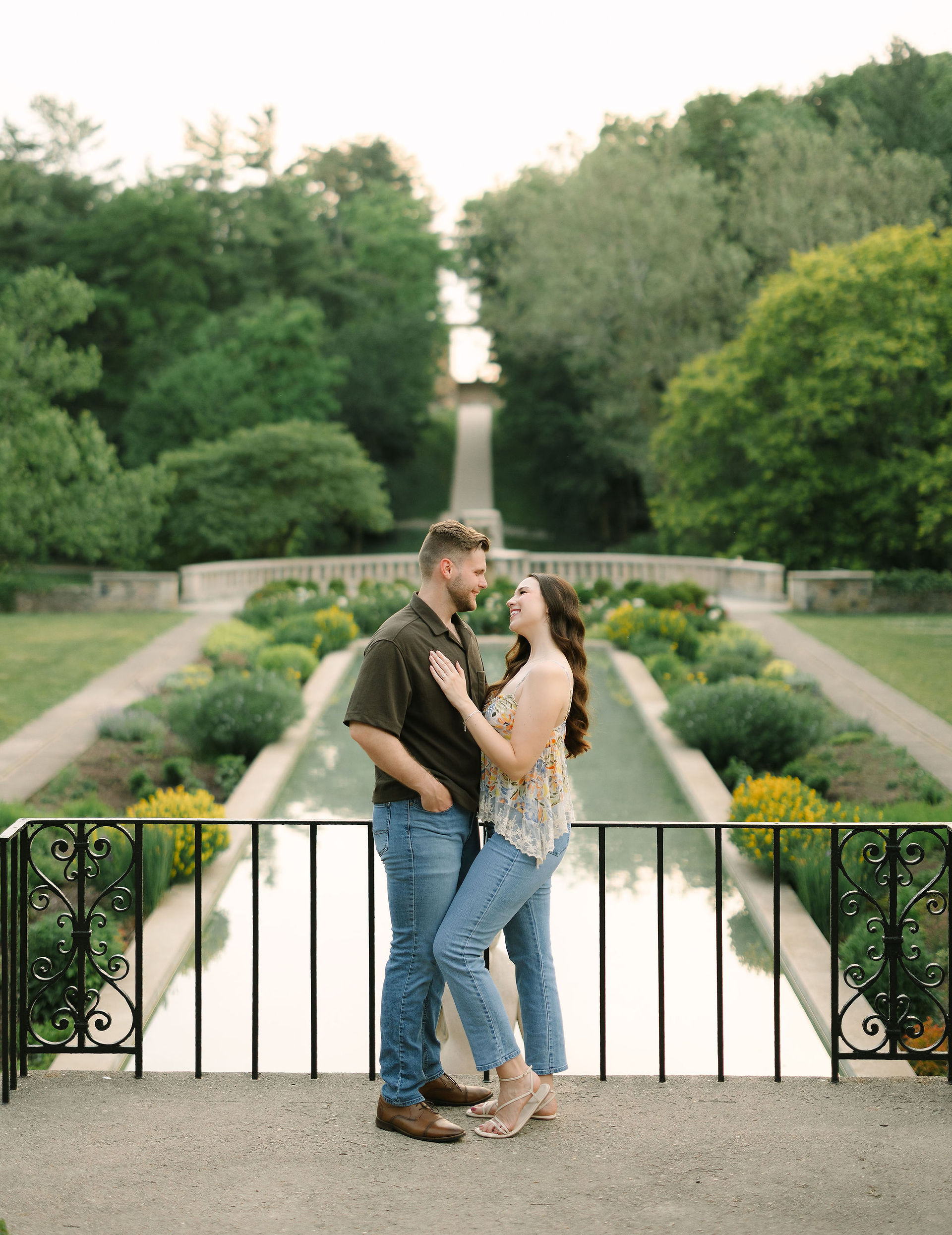 Romantic engagement photos at Cranbrook House & Gardens with blooming spring flowers in Oakland County.
