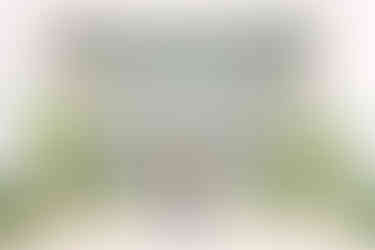 Couple embracing during engagement photos in front of the historic Michigan Central Station in Detroit